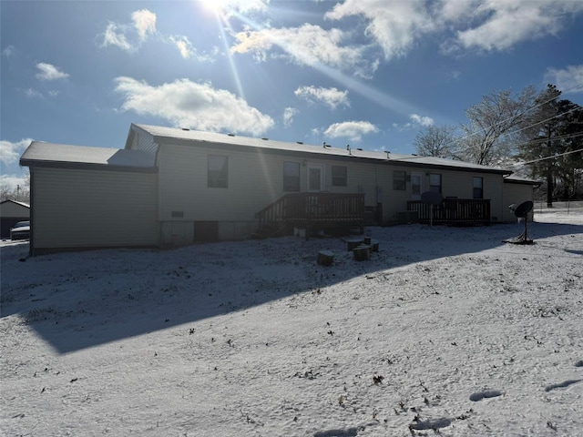 back of property featuring a wooden deck