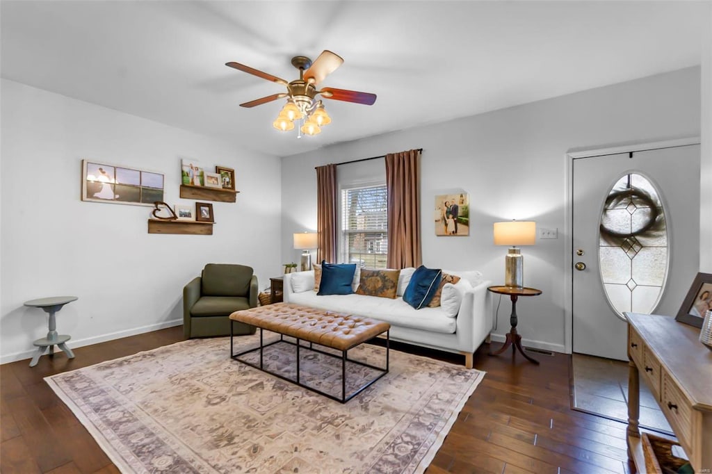 living room with ceiling fan and dark wood-type flooring