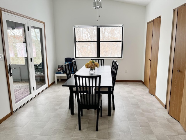 dining space featuring lofted ceiling