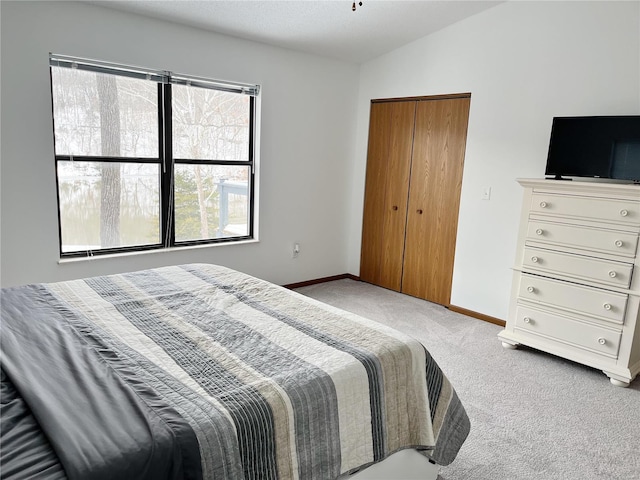 carpeted bedroom featuring vaulted ceiling and multiple windows