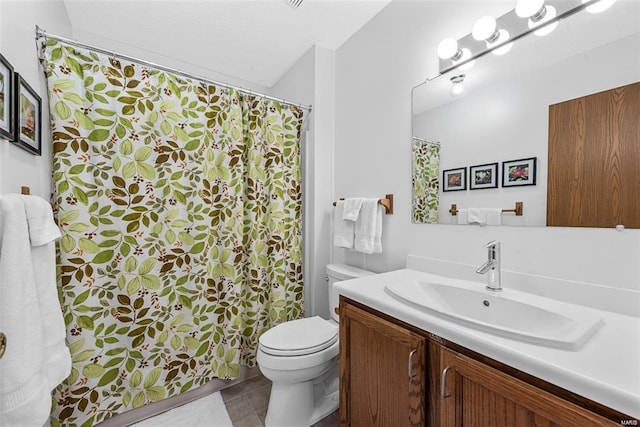 bathroom featuring toilet, tile patterned floors, and vanity