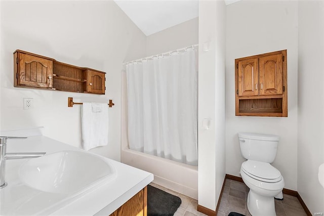 full bathroom with sink, tile patterned flooring, shower / bath combo with shower curtain, and toilet