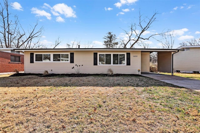 ranch-style home with a front lawn and a carport