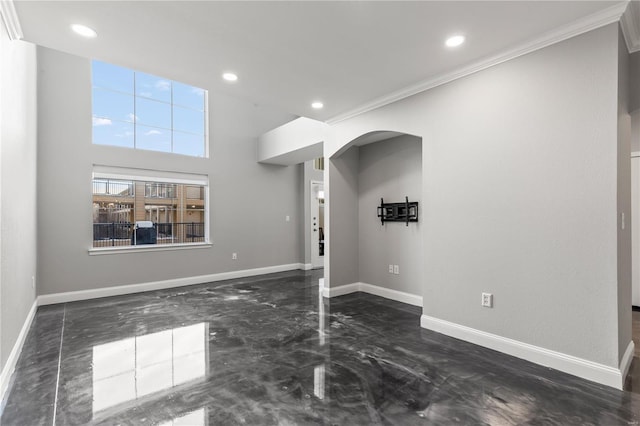 unfurnished living room featuring crown molding