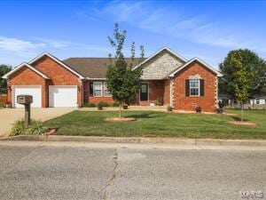 ranch-style home featuring a garage and a front lawn