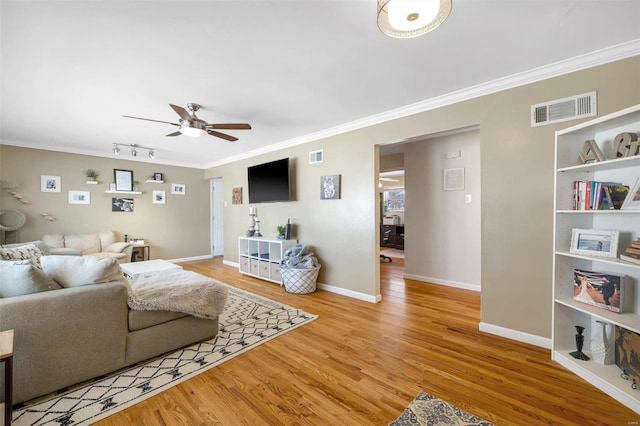 living room with ornamental molding, ceiling fan, light hardwood / wood-style flooring, and rail lighting