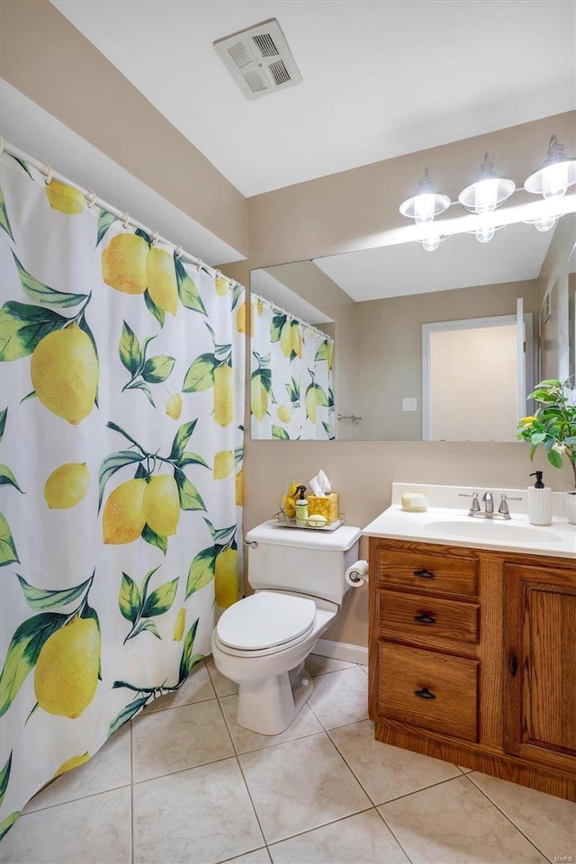 bathroom featuring toilet, tile patterned flooring, and vanity