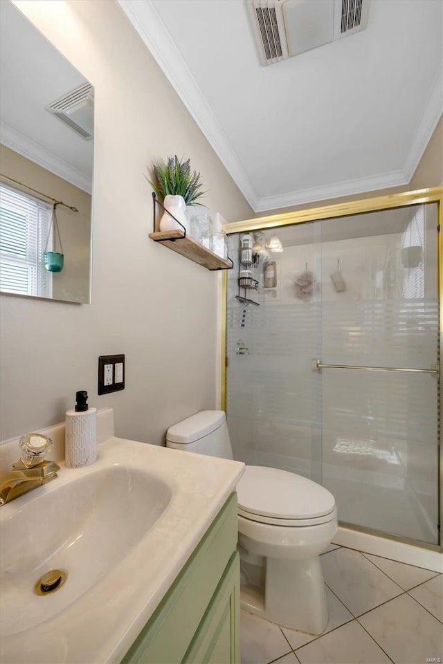 bathroom with tile patterned flooring, toilet, a shower with door, vanity, and crown molding