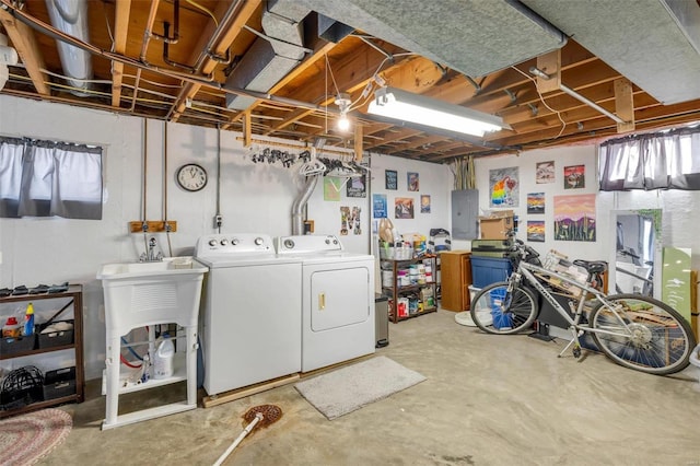 laundry area with electric panel and washing machine and dryer