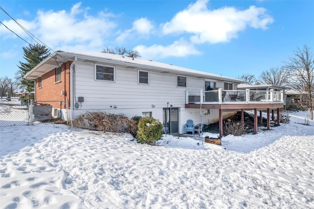 snow covered house with a deck