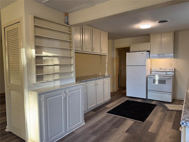 kitchen featuring white appliances, dark wood-type flooring, and white cabinets