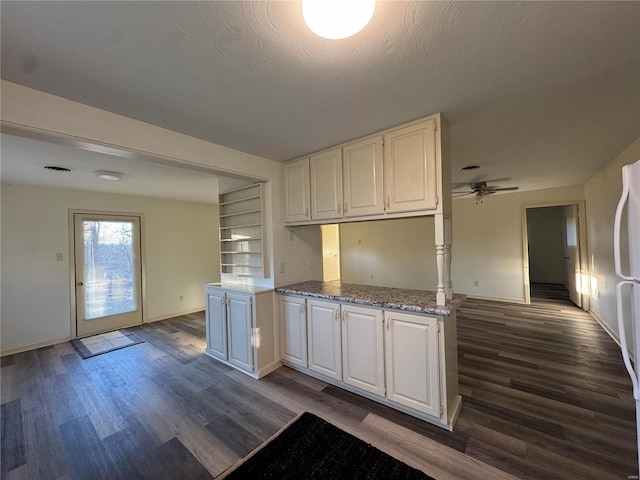 kitchen with white cabinets, ceiling fan, and dark hardwood / wood-style floors