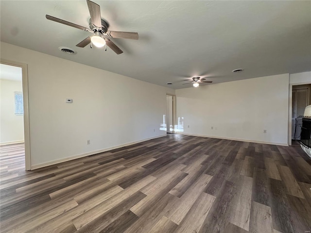 unfurnished living room featuring ceiling fan and dark hardwood / wood-style floors