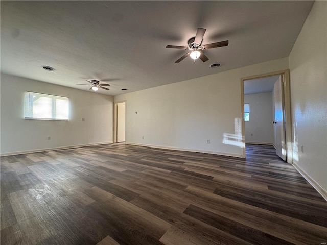 empty room with ceiling fan and dark hardwood / wood-style floors