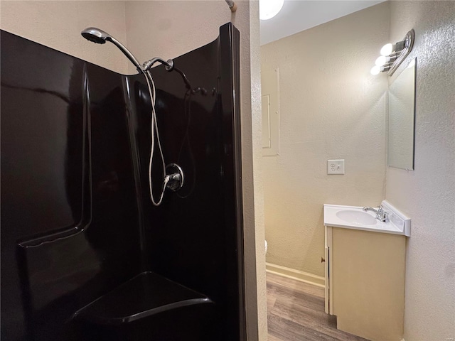 bathroom featuring vanity, hardwood / wood-style floors, and walk in shower