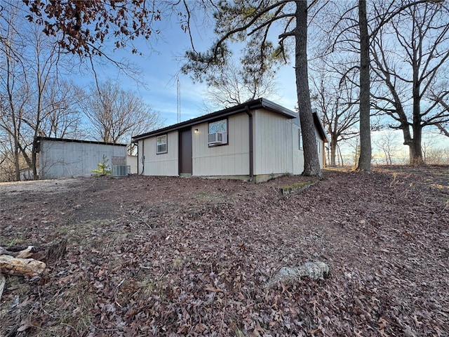 rear view of house with central air condition unit and cooling unit