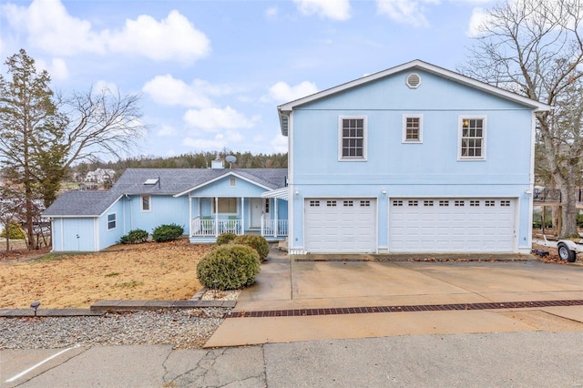 view of property with covered porch and a garage