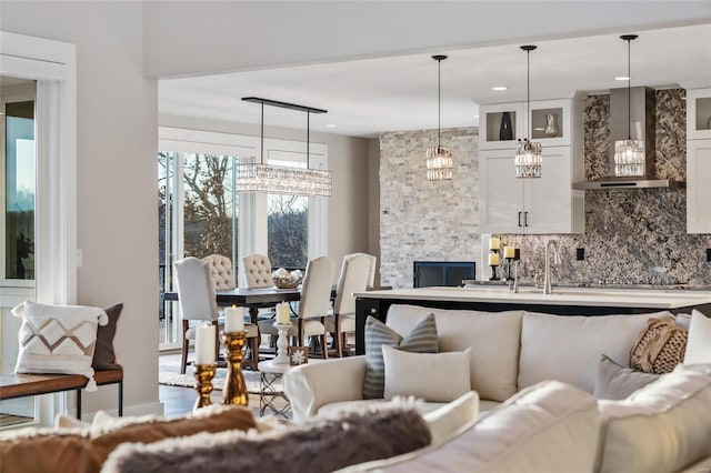 living room with a fireplace and sink