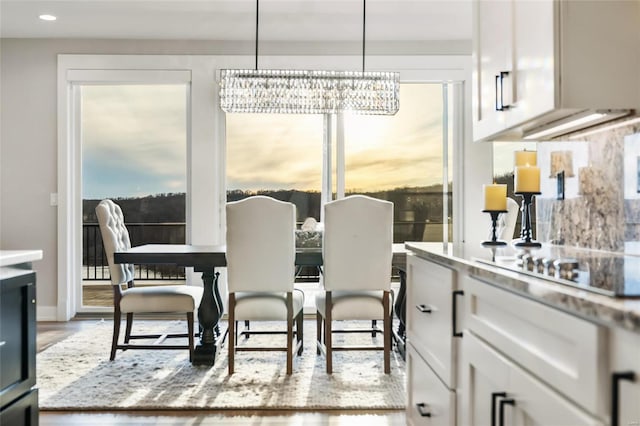 dining space featuring a chandelier and light wood-type flooring