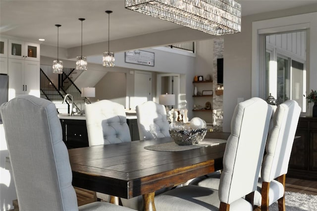 dining space with hardwood / wood-style flooring and sink