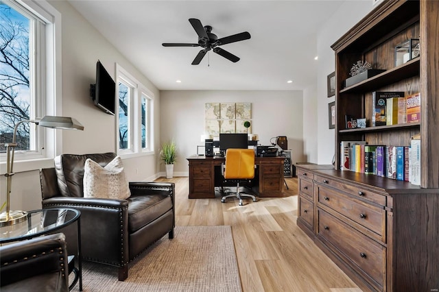 office featuring a healthy amount of sunlight, ceiling fan, and light hardwood / wood-style floors