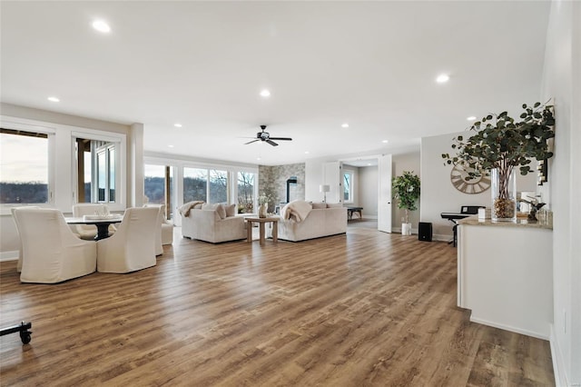 living room featuring ceiling fan and hardwood / wood-style flooring