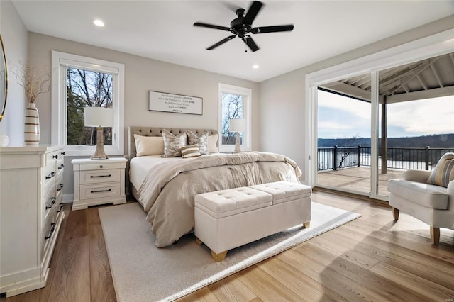 bedroom with wood-type flooring, access to outside, and ceiling fan