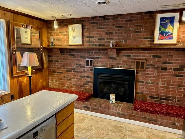 living room featuring track lighting and a brick fireplace