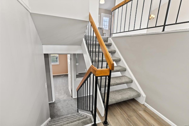 stairs featuring hardwood / wood-style flooring