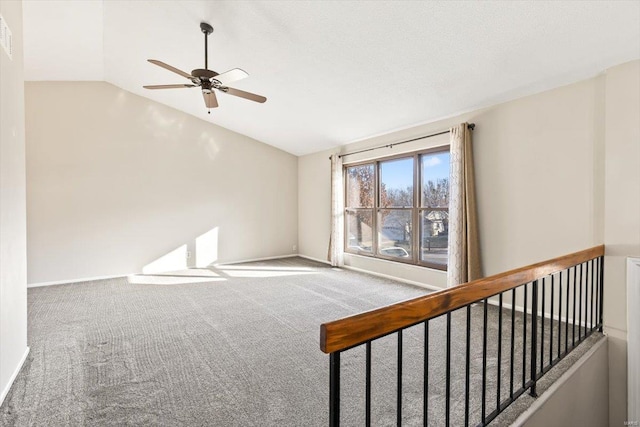 empty room featuring carpet flooring, ceiling fan, and lofted ceiling