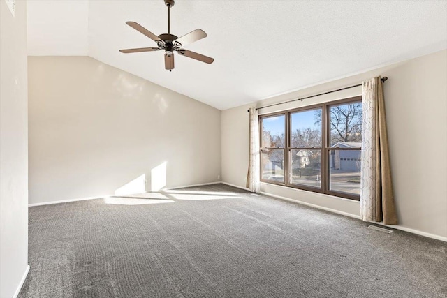 carpeted spare room with ceiling fan and lofted ceiling