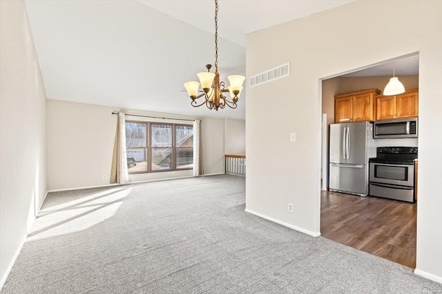 interior space featuring dark carpet, vaulted ceiling, and a notable chandelier