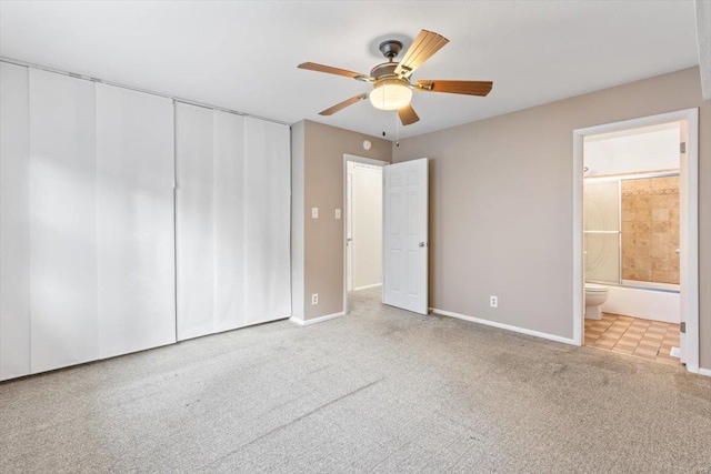 unfurnished bedroom with connected bathroom, light colored carpet, and ceiling fan