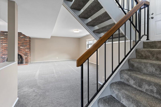 stairs featuring a fireplace and carpet