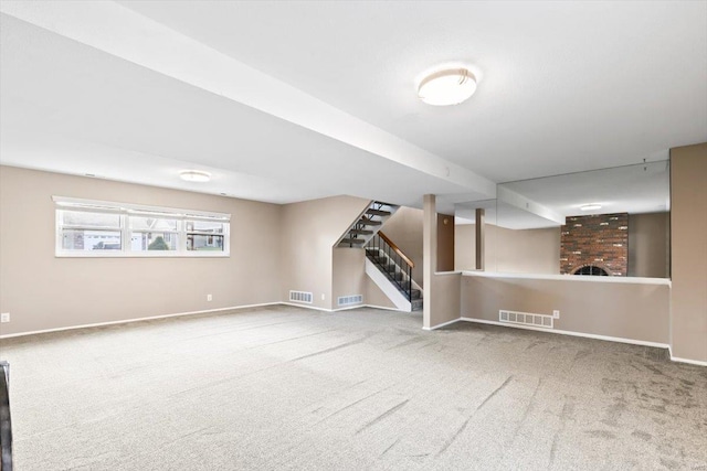 basement featuring carpet and a brick fireplace