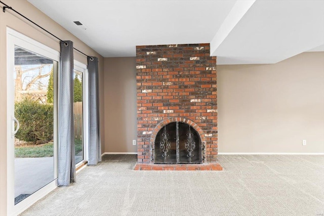 unfurnished living room featuring carpet flooring and a fireplace