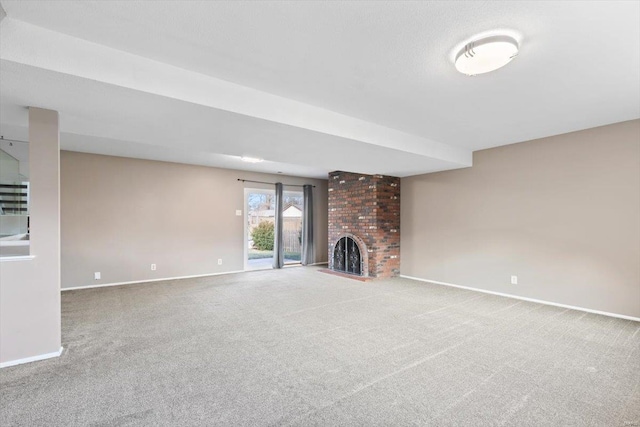 unfurnished living room with carpet floors and a fireplace