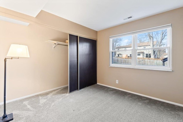 unfurnished bedroom featuring carpet flooring and a closet