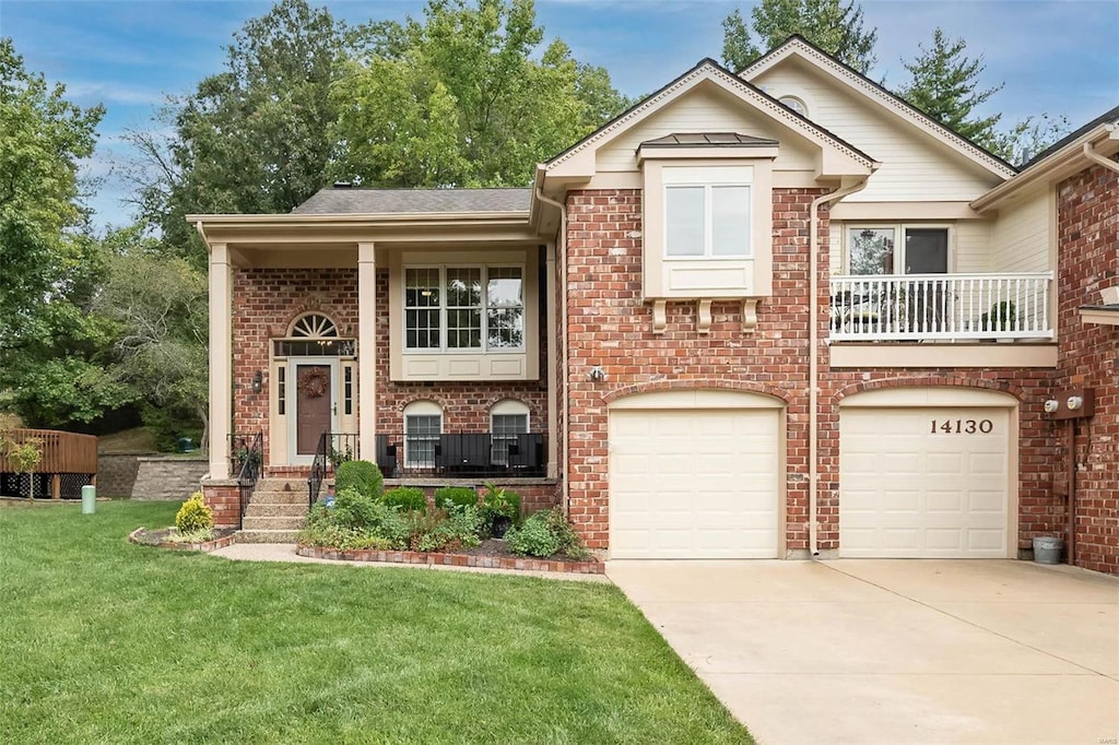 view of front of house featuring a garage and a front lawn