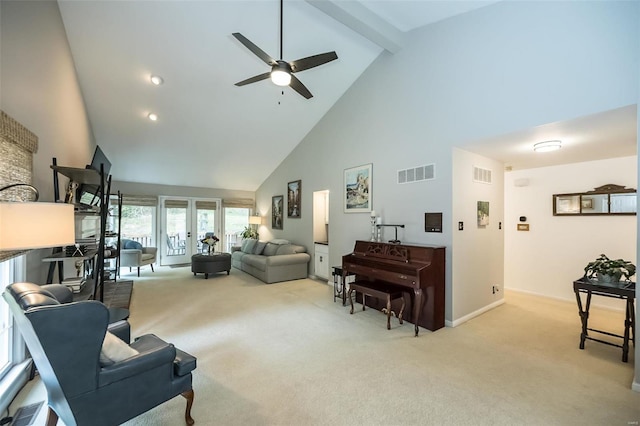 living room with beamed ceiling, ceiling fan, light colored carpet, and high vaulted ceiling