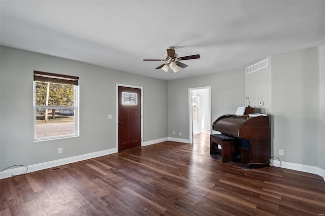 entryway with visible vents, ceiling fan, baseboards, and wood finished floors