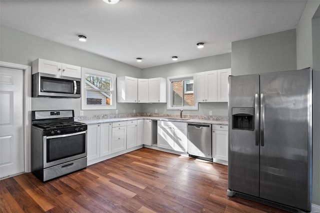 kitchen featuring dark wood finished floors, plenty of natural light, white cabinets, and stainless steel appliances