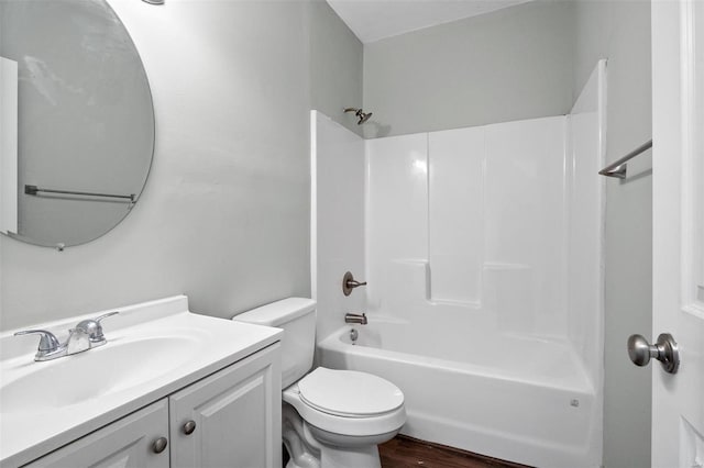 bathroom featuring toilet, vanity, shower / bathing tub combination, and wood finished floors