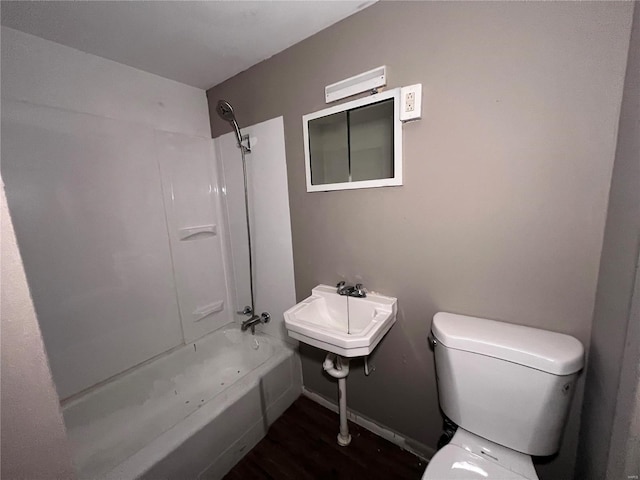 bathroom featuring hardwood / wood-style flooring, bathtub / shower combination, and toilet