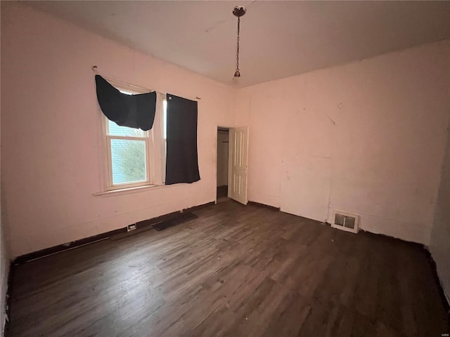 empty room featuring dark hardwood / wood-style flooring