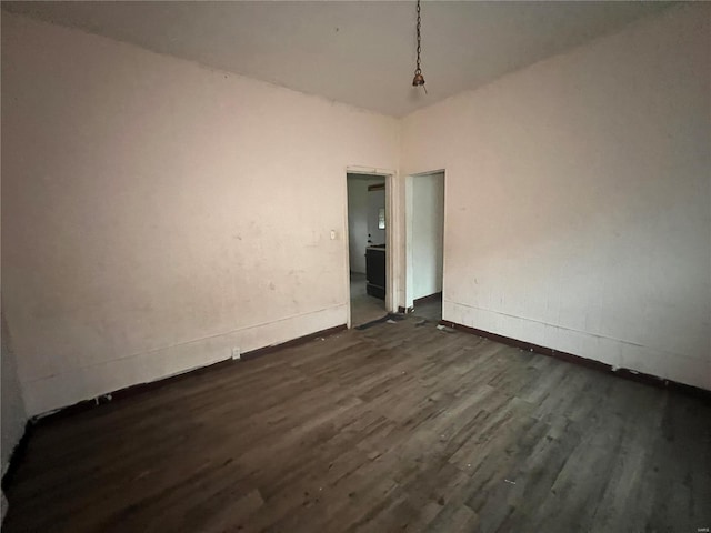 unfurnished room with dark hardwood / wood-style flooring