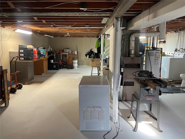 basement featuring gas water heater and washing machine and dryer