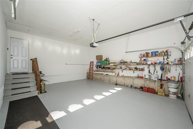 garage with a garage door opener and a workshop area