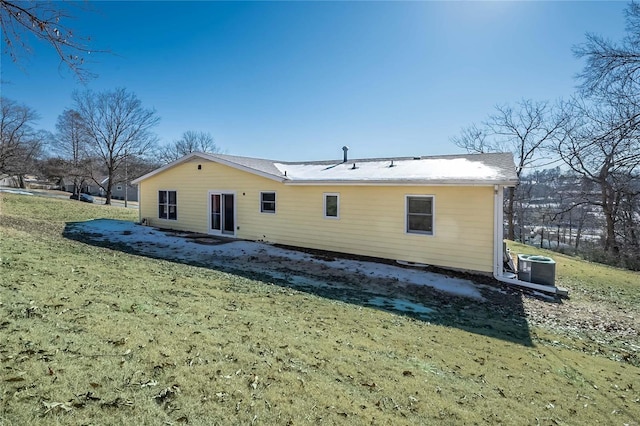 back of property with a yard and central air condition unit