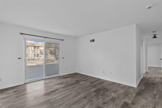 unfurnished room with dark hardwood / wood-style floors